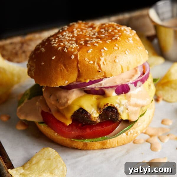 Fall-Apart Oven Chuck Roast Recipe for Tender, Juicy Beef 6 Finished cheeseburger on a sesame bun with lettuce, tomato, and red onion.