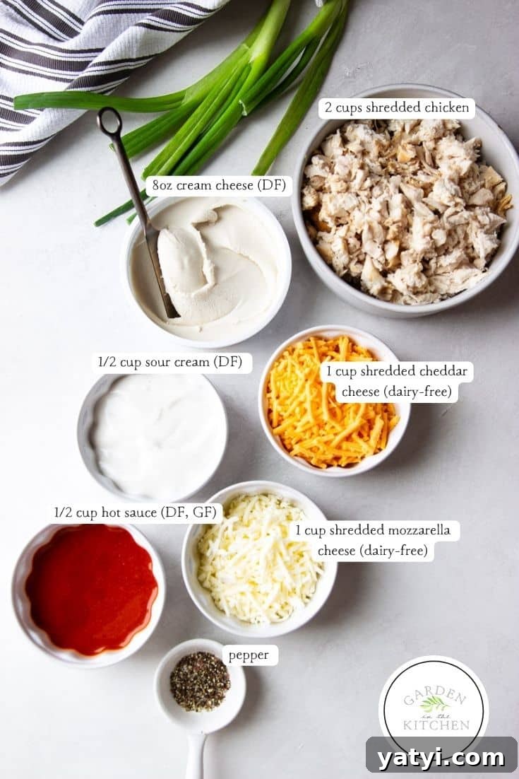 Creamy Buffalo Chicken Dip Recipe for Game Day or Parties 4 Green onions, dairy free cream cheese, shredded chicken, dairy free cheddar cheese, dairy free sour cream, hot sauce, dairy free mozzarella cheese, pepper.