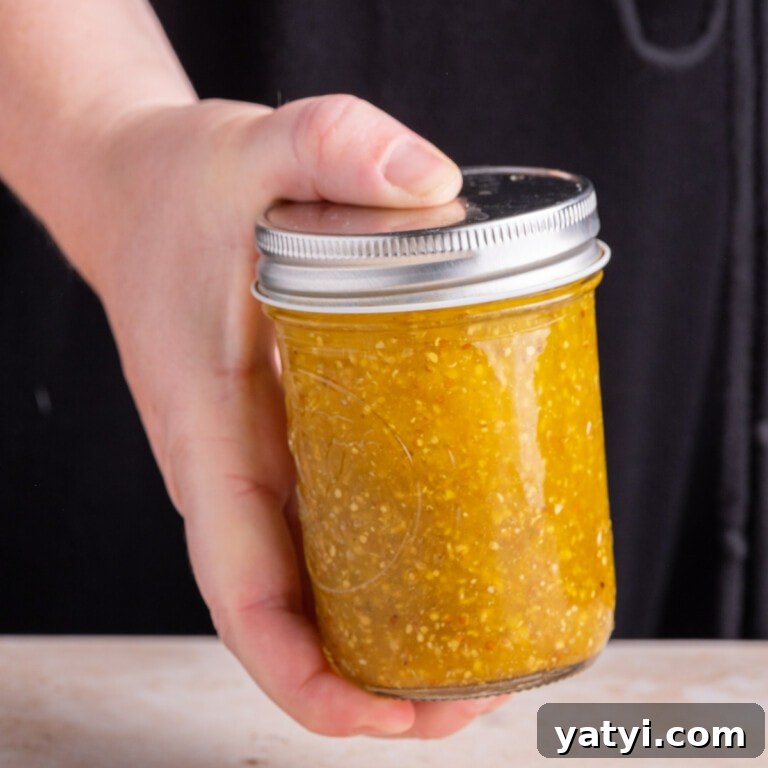 Shaking a jar with all ingredients for Maple Dijon Vinaigrette to emulsify it