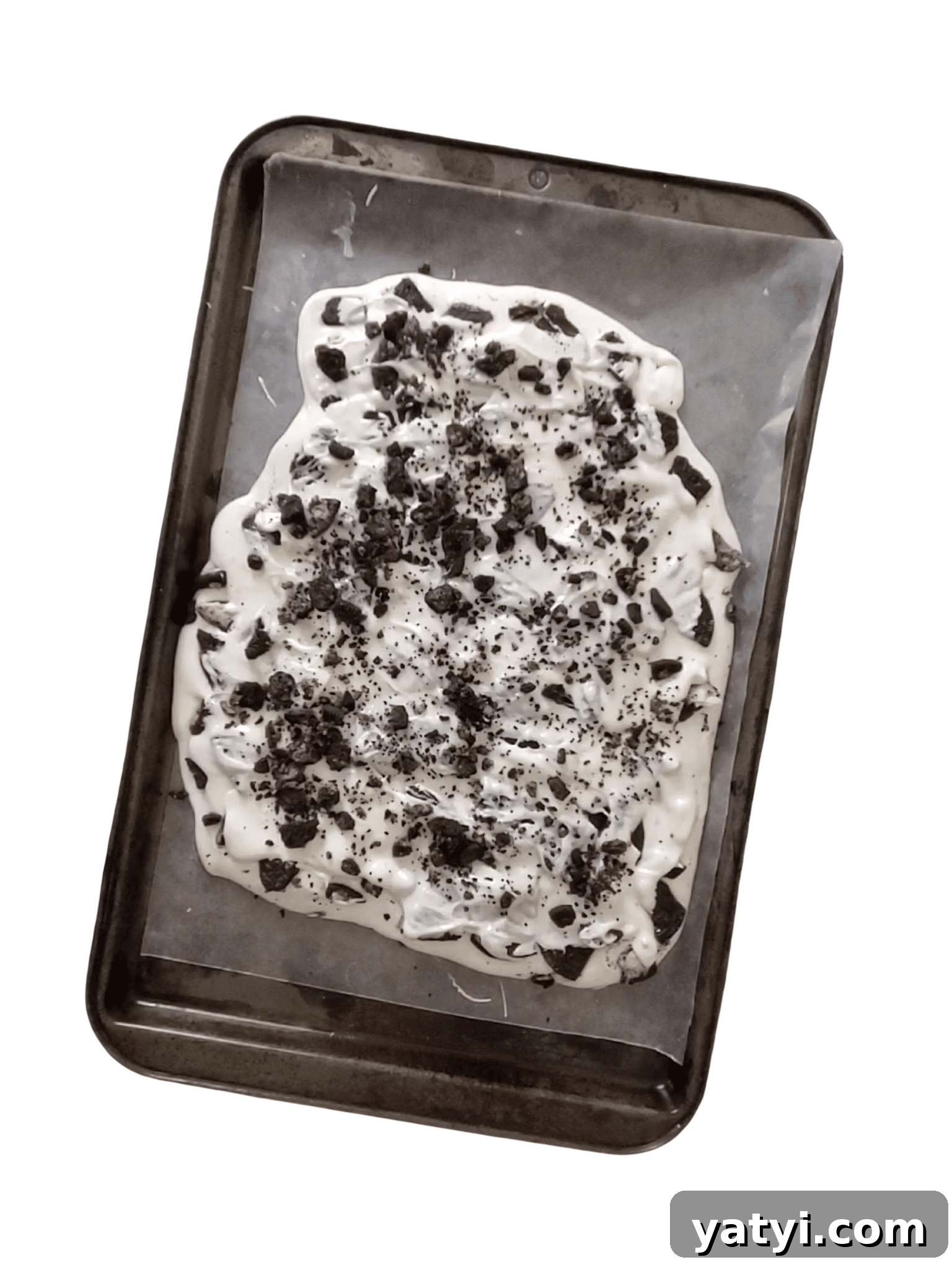 oreo cookies being spread in white chocolate
