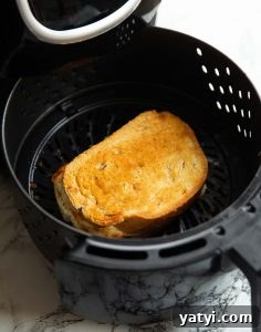 Air Fryer Grilled Cheese close up shot of grilled cheese in air fryer