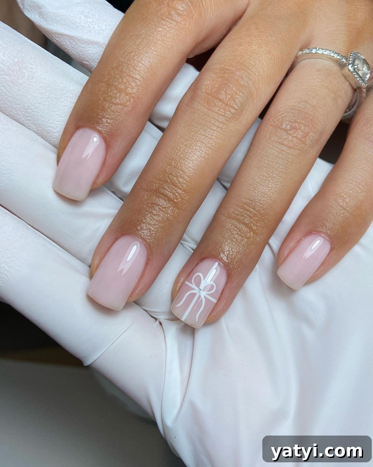 41 Chic Nude Nail Ideas You Can Create at Home 8 6. Christmas Bow Accent