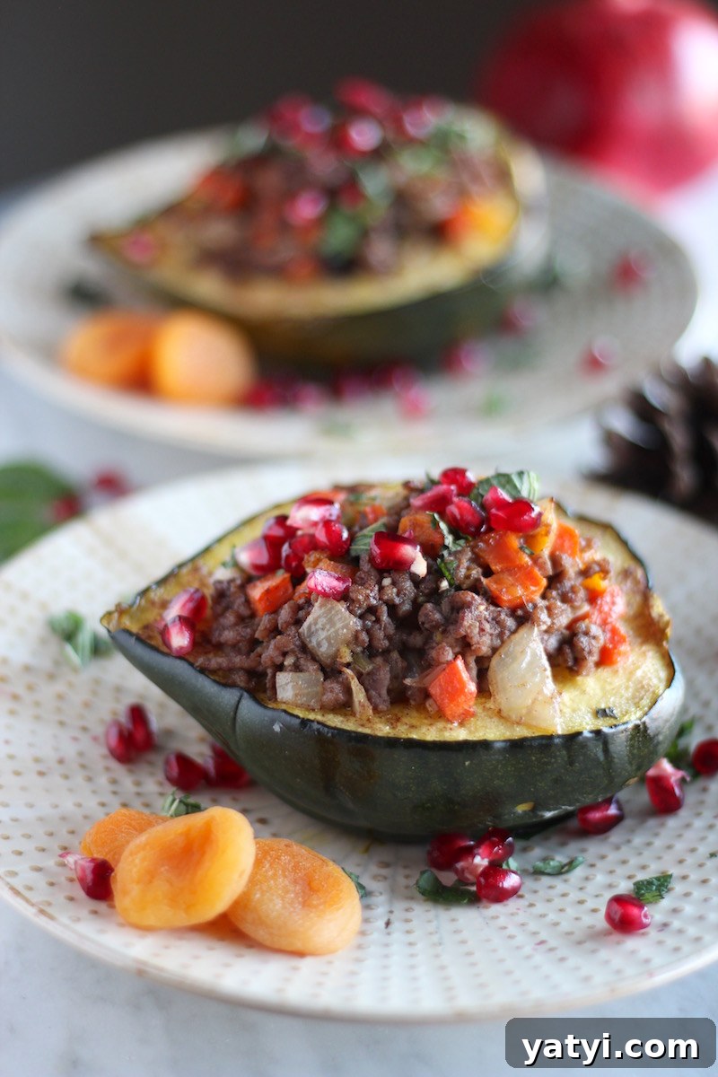 Paleo Moroccan Lamb Stuffed Squash (AIP) - a beautiful, flavorful meal featuring roasted squash, grassfed lamb, fresh mint, apricots, and pomegranate seeds! | fedandfulfilled.com