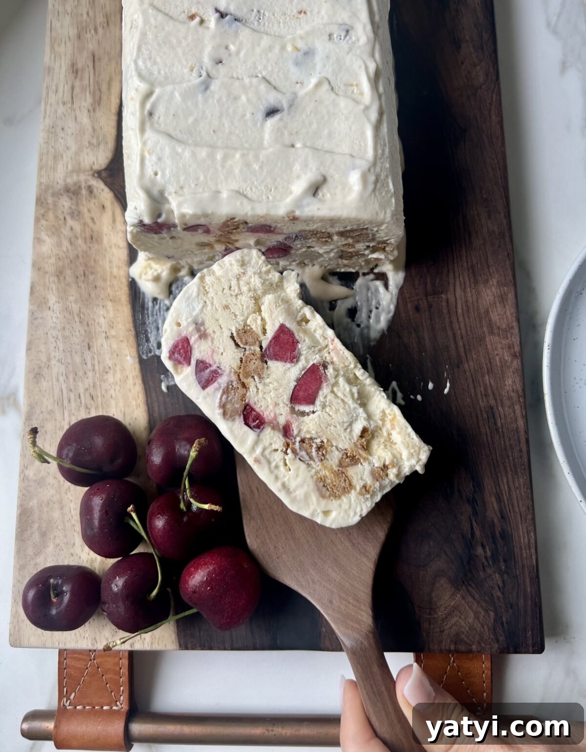 Semifreddo with Crushed Biscotti and Cherry Swirl 2 a slice of semifreddo with cherries and cookies inside.