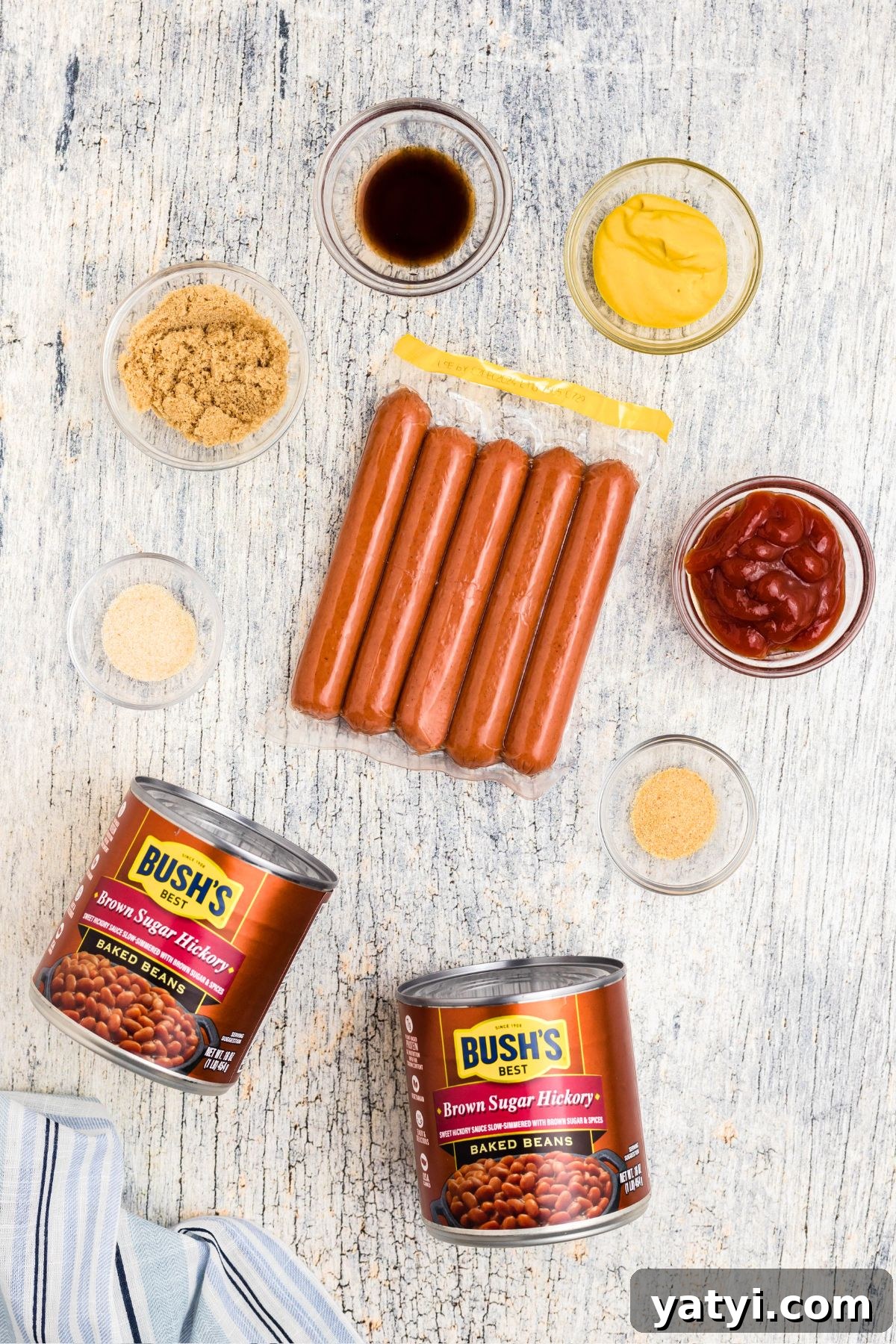 Classic Beanie Weenies Recipe: Hearty Sausage and Beans Meal 3 Ingredients needed to make beanie weenies, measured in small glass bowls.