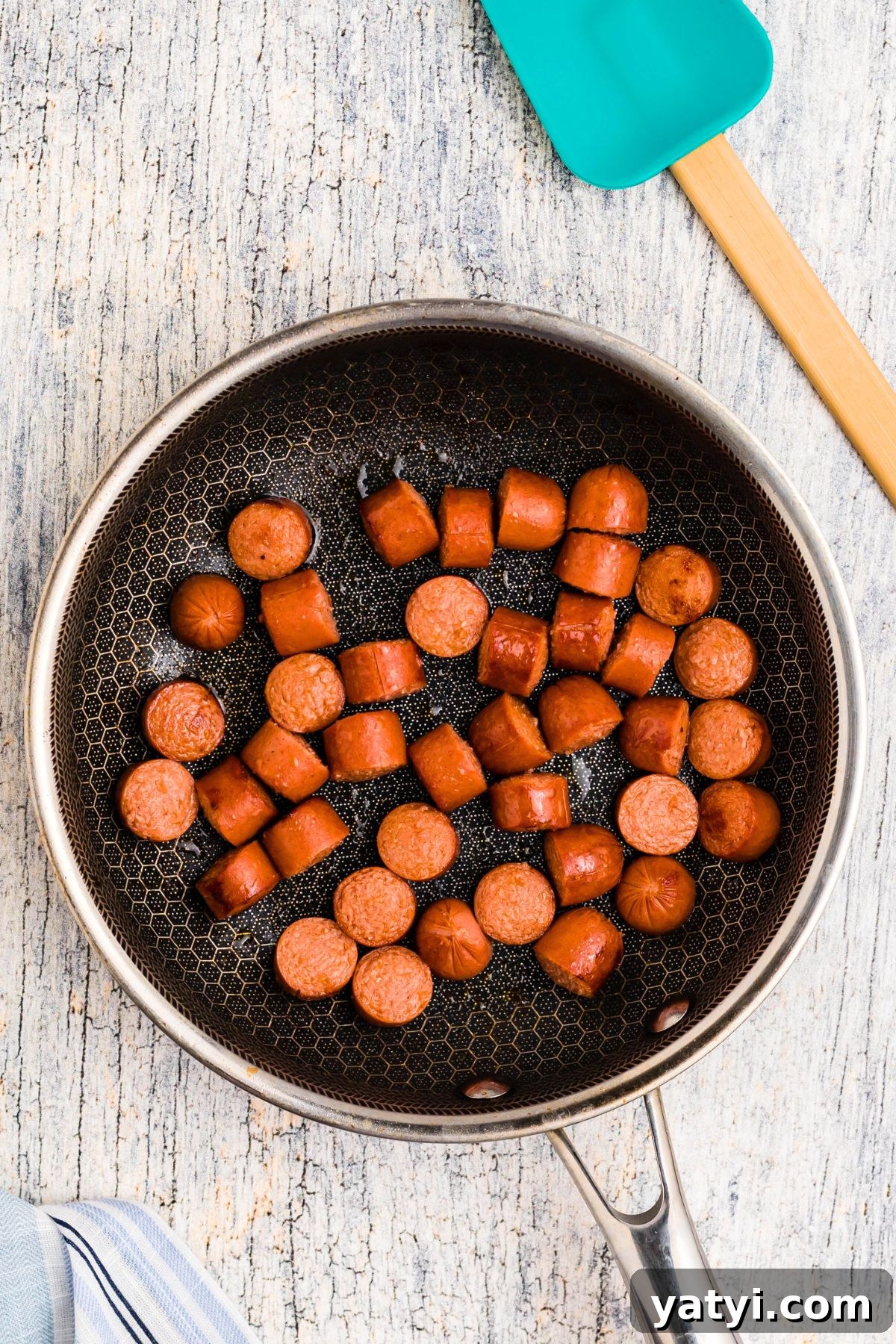 Classic Beanie Weenies Recipe: Hearty Sausage and Beans Meal 4 Hot dogs cut into slices, browned in a skillet.