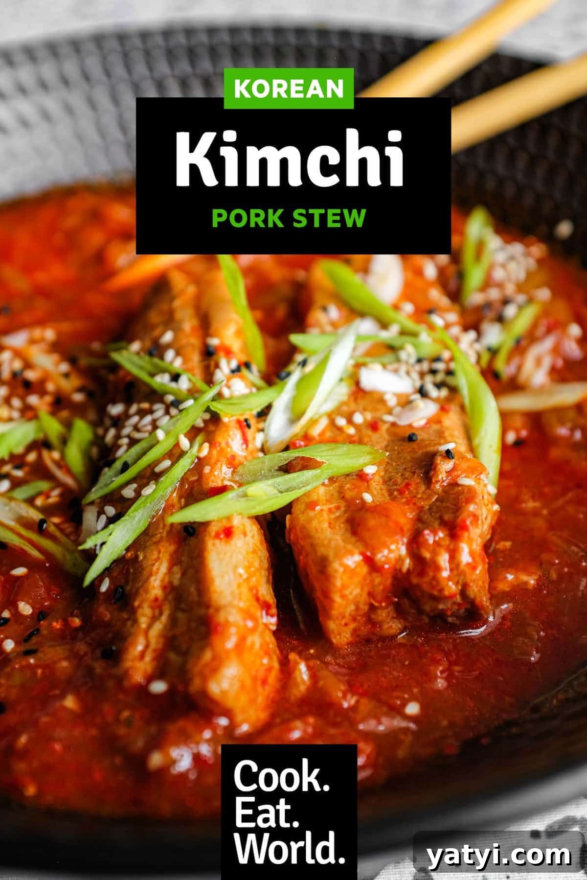 Kimchi Pork Stew | cookeatworld.com A large black bowl of Kimchi Pork Stew scattered with sesame seeds, nigella seeds and spring onion