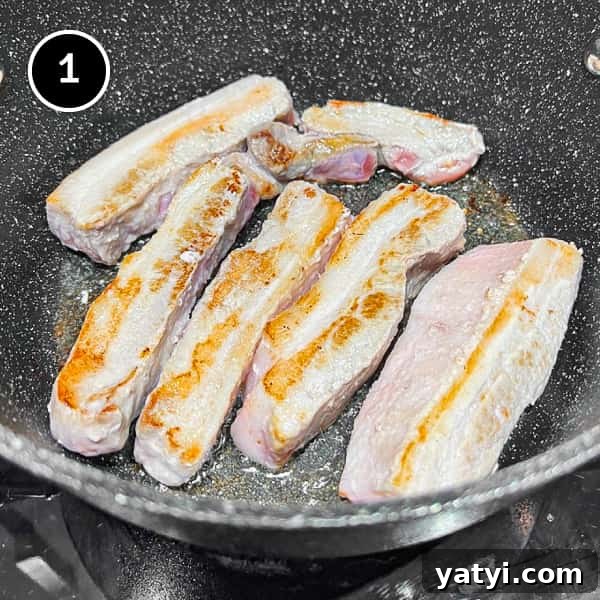 Kimchi Pork Stew | cookeatworld.com Searing thick strips of pork belly in a large pan