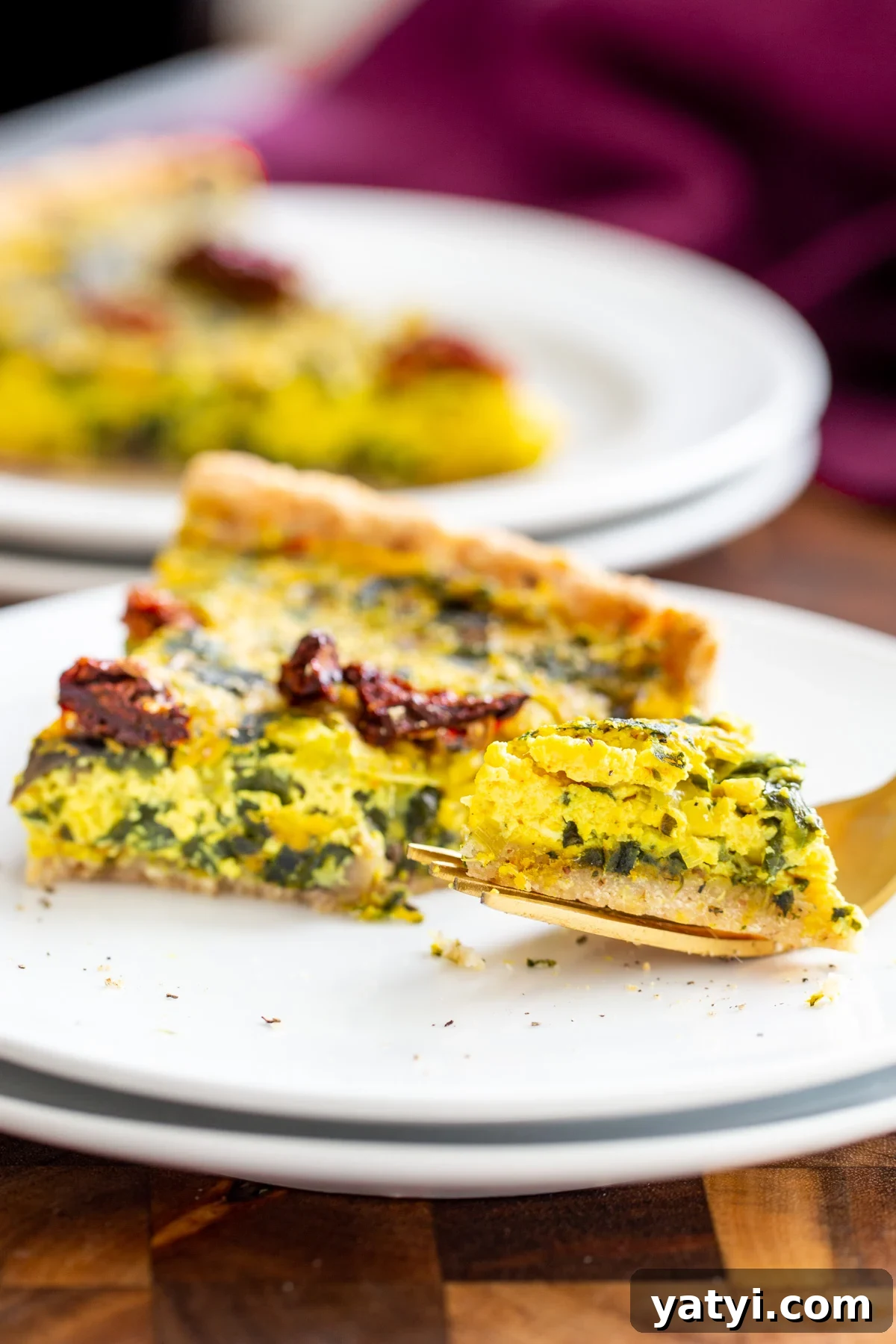 Vegan Mushroom, Spinach & Leek Quiche Recipe 6 a fork taking out a piece of a slice of vegan quiche