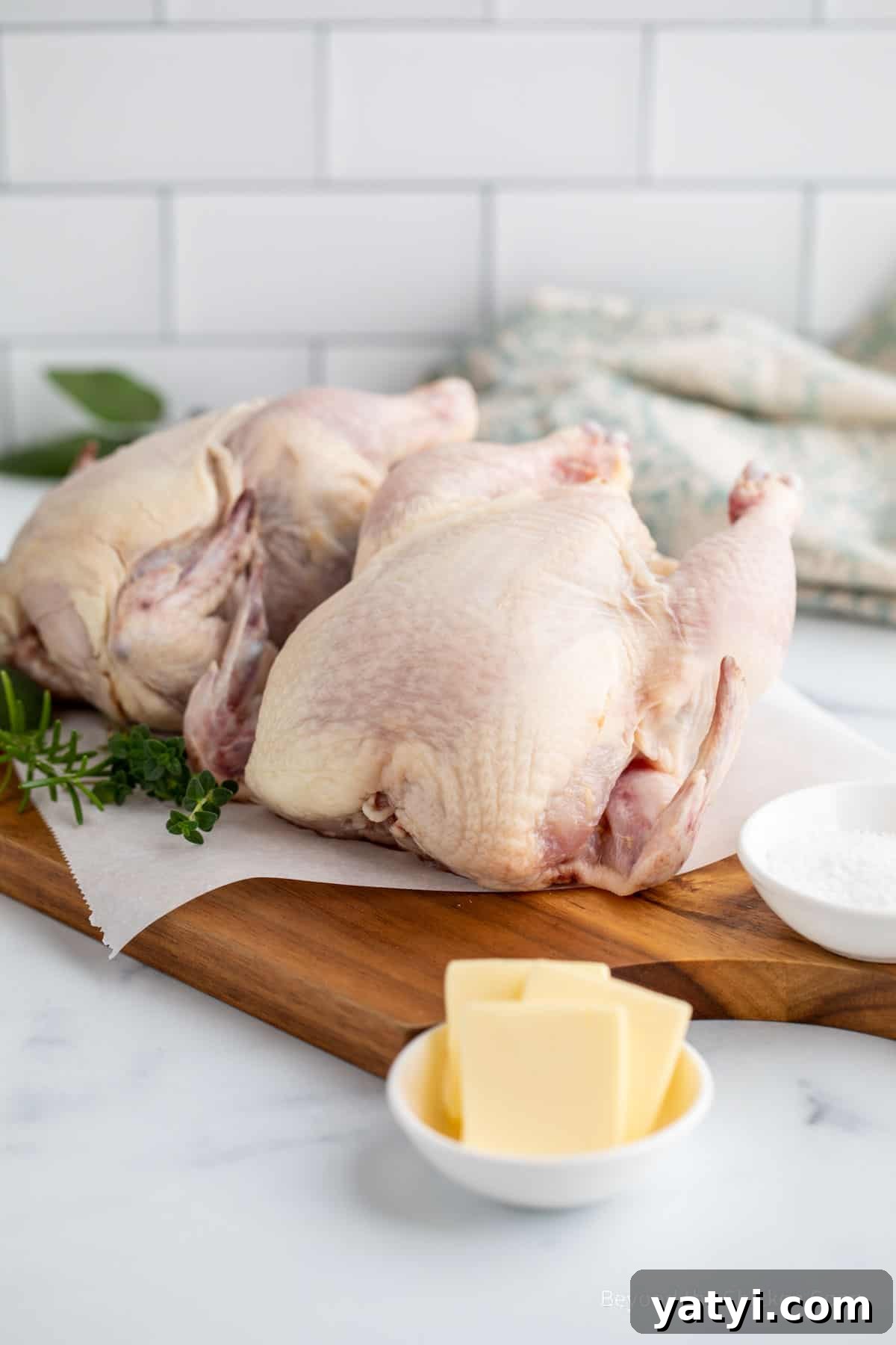 Herb-Roasted Stuffed Cornish Hens with Garlic and Lemon 3 Two cornish hens on a cutting board.