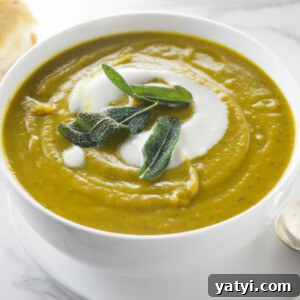 A bowl of sweet potato soup with fried sage on top.