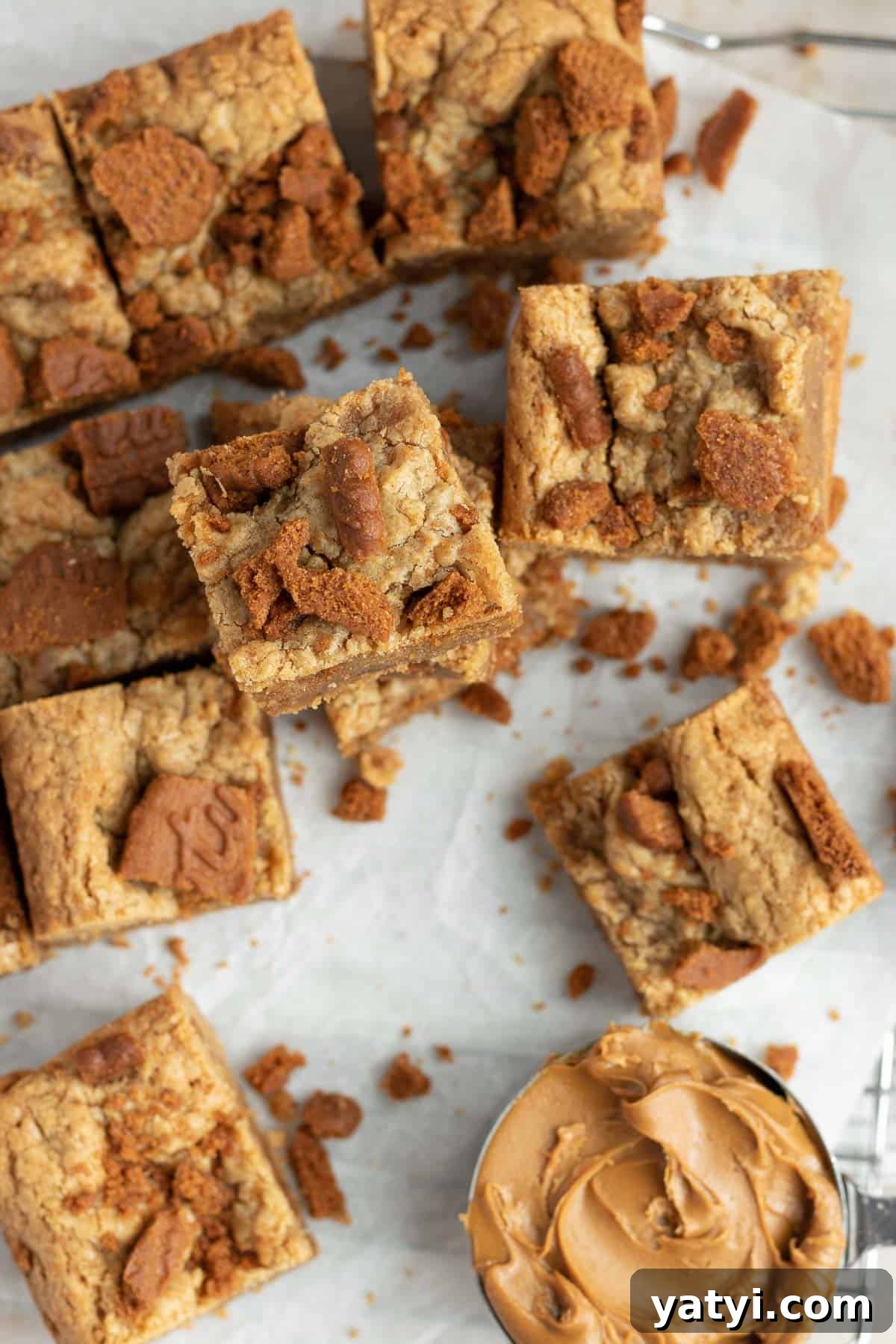Chewy Biscoff Blondies with Caramelized Lotus Spread 3 a pile of Biscoff blondies sitting on parchment paper