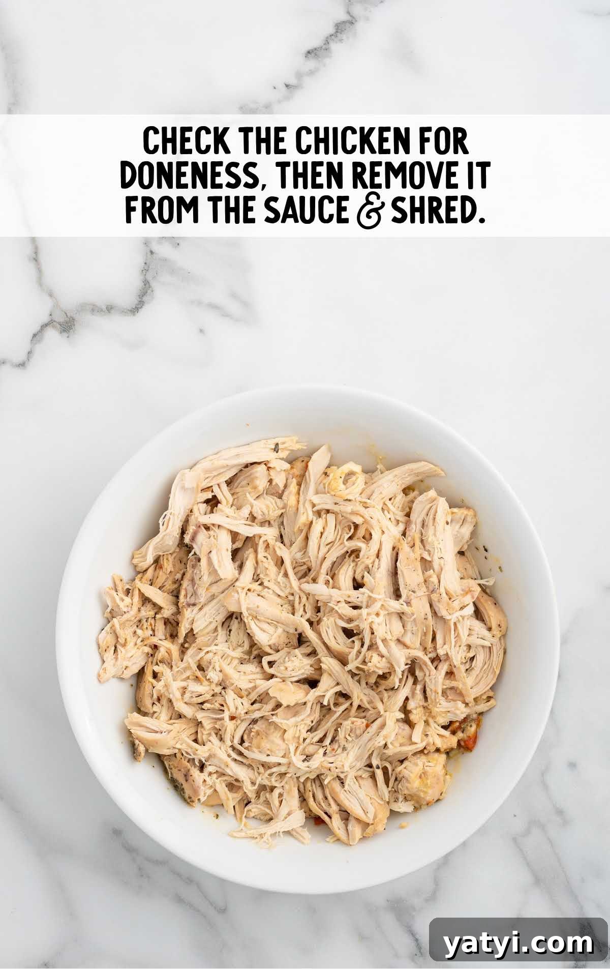 Creamy Slow Cooker Chicken Spaghetti Recipe for Weeknight Meals 5 cooked chicken shredded in a bowl