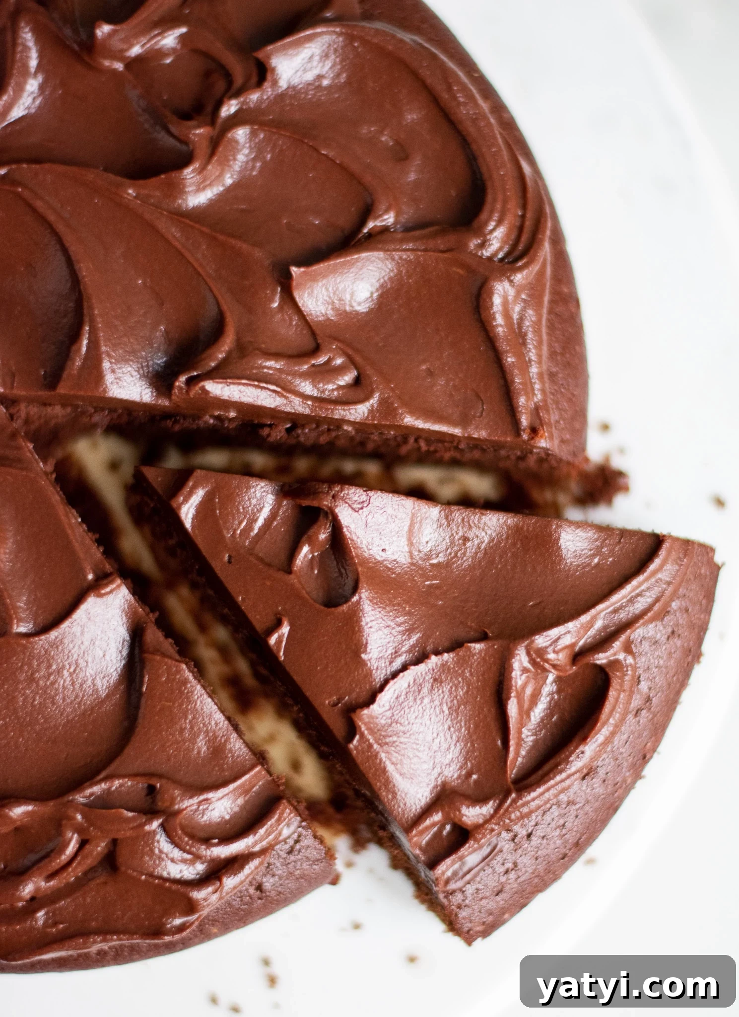 Classic Danish Chocolate Cake Recipe — Moist, Rich & Simple 2 A chocolate cake with a slice cut out of it.