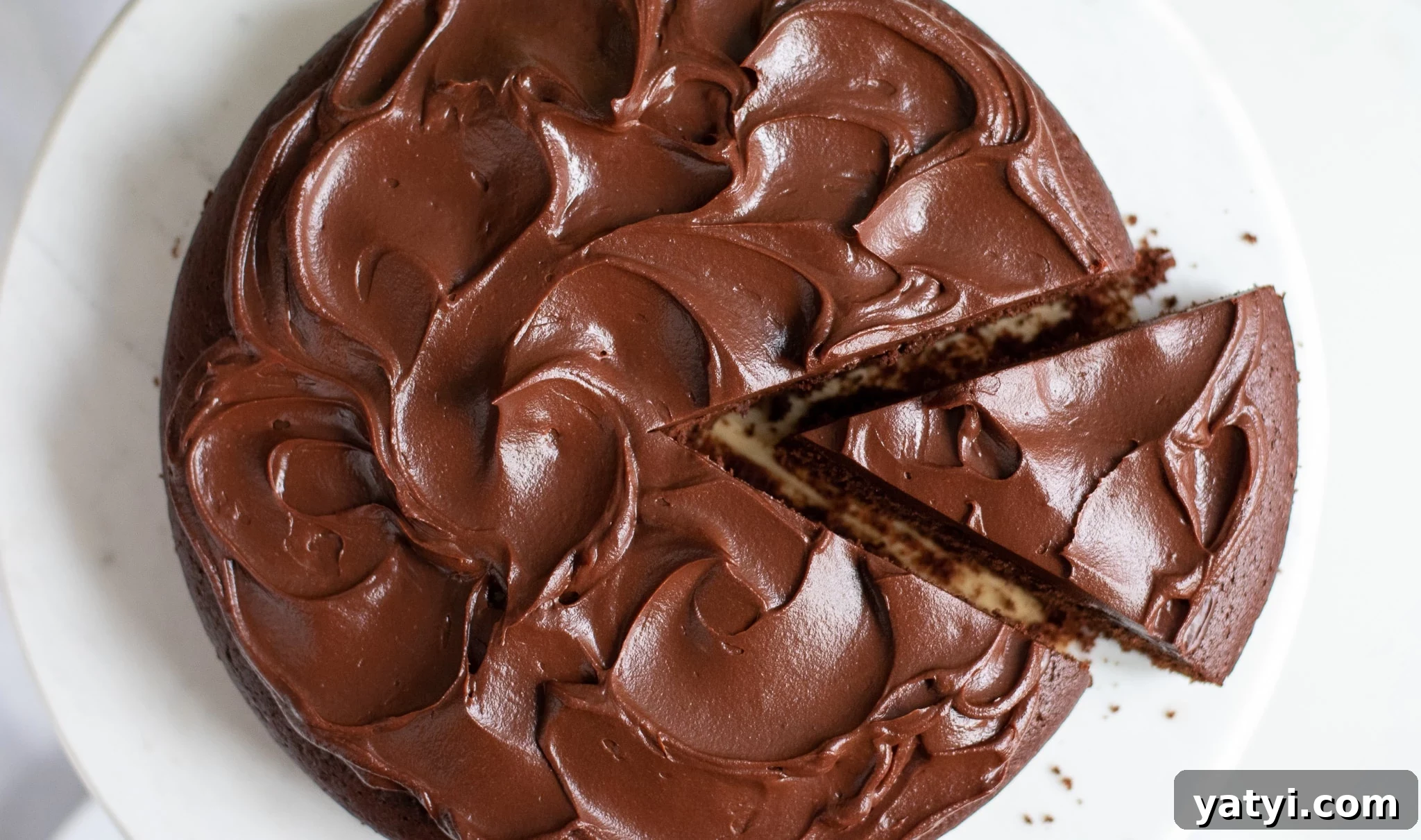 Classic Danish Chocolate Cake Recipe — Moist, Rich & Simple 5 A chocolate cake with a slice cut out of it.
