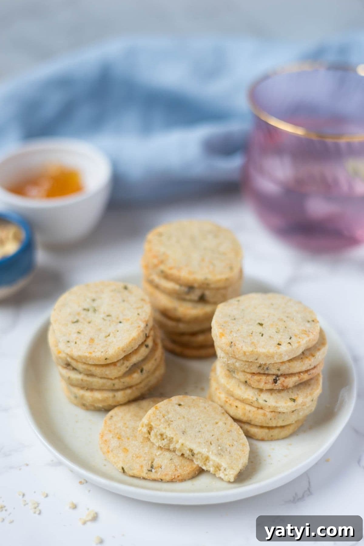 Rosemary Parmesan Shortbread Made with Sourdough Discard 3 Stacked sourdough discard rosemary and parmesan shortbread on a serving plate.