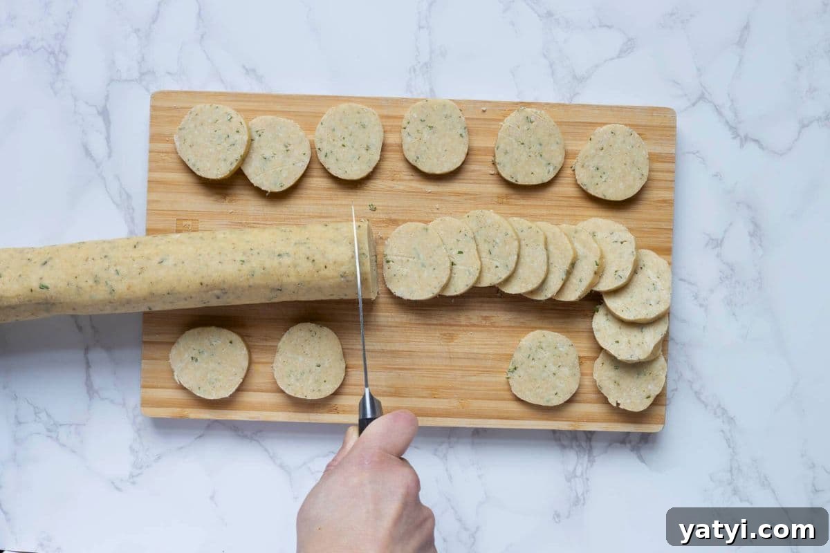 Rosemary Parmesan Shortbread Made with Sourdough Discard 7 Slicing the sourdough discard rosemary and parmesan shortbread dough to make the biscuits.