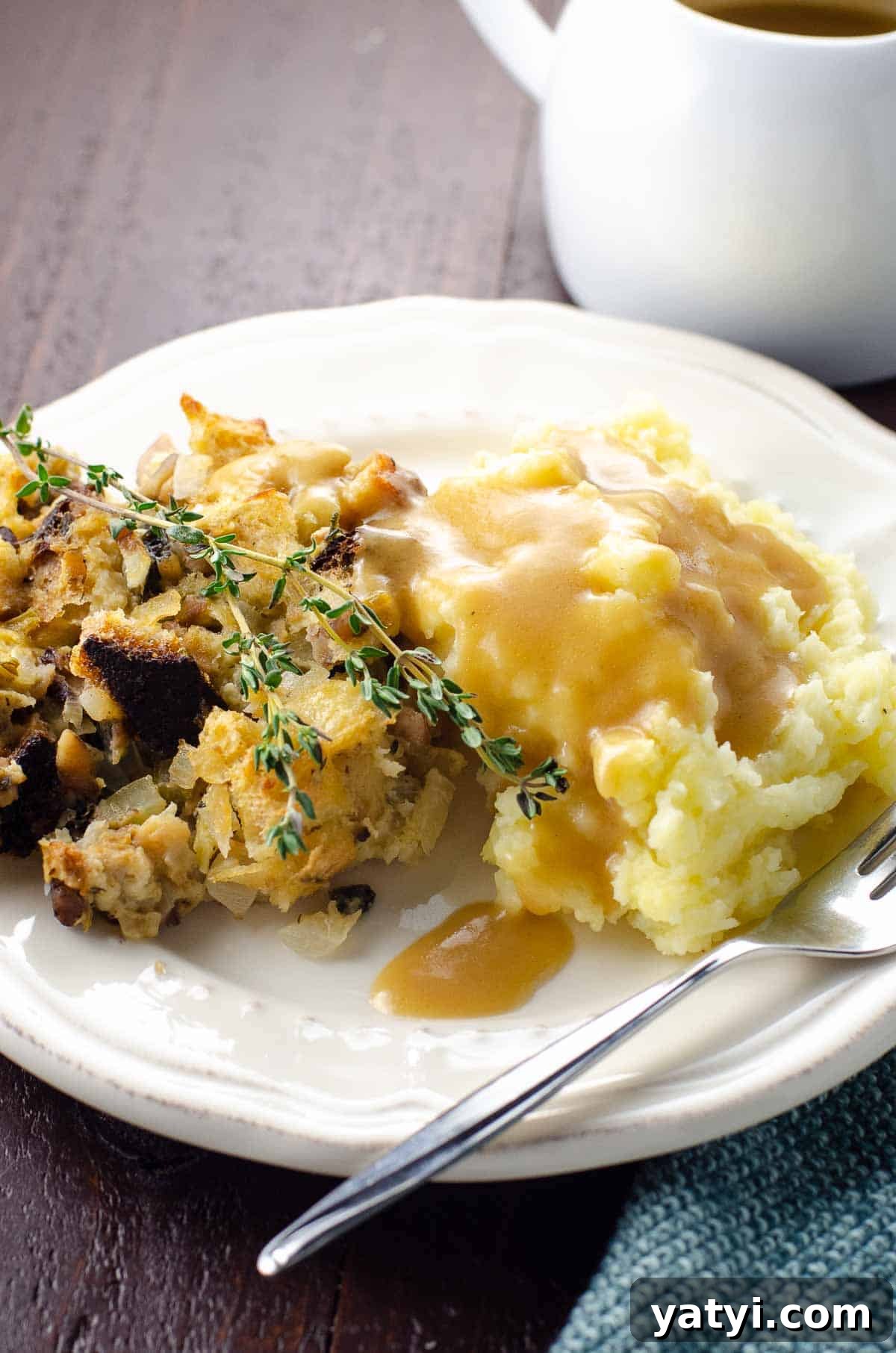 Vegan Thanksgiving Menu Ideas: Plant-Based Dishes to Impress 2 vegan stuffing and mashed potatoes on a plate with vegan gravy