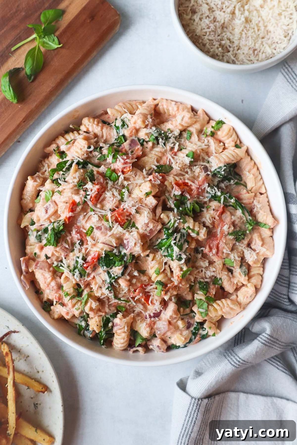 Creamy Boursin Tomato Pasta Bake — Viral TikTok Recipe 7 white bowl with boursin tomato pasta topped with parmesan cheese
