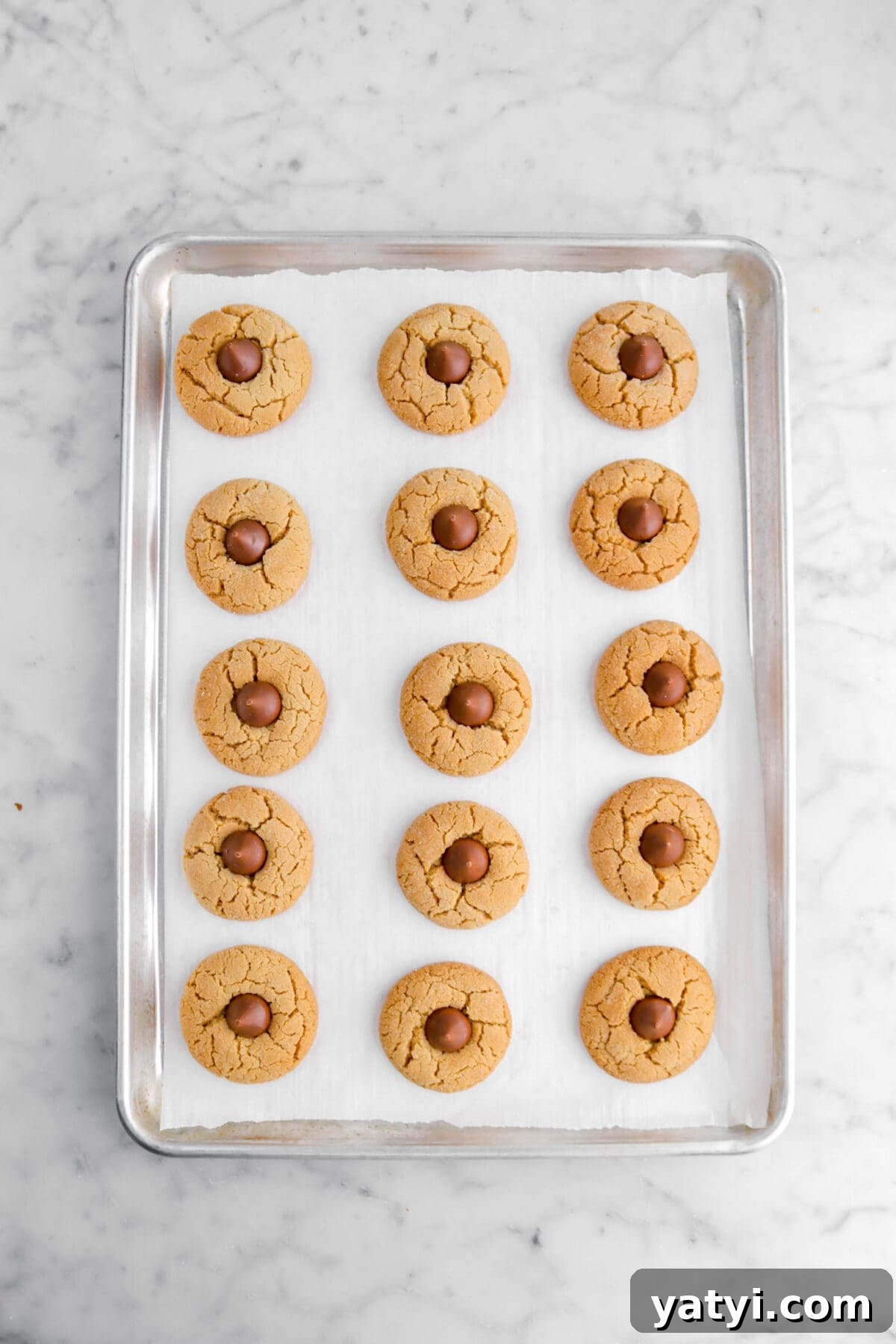 chocolate kisses placed in the center of each baked cookie.