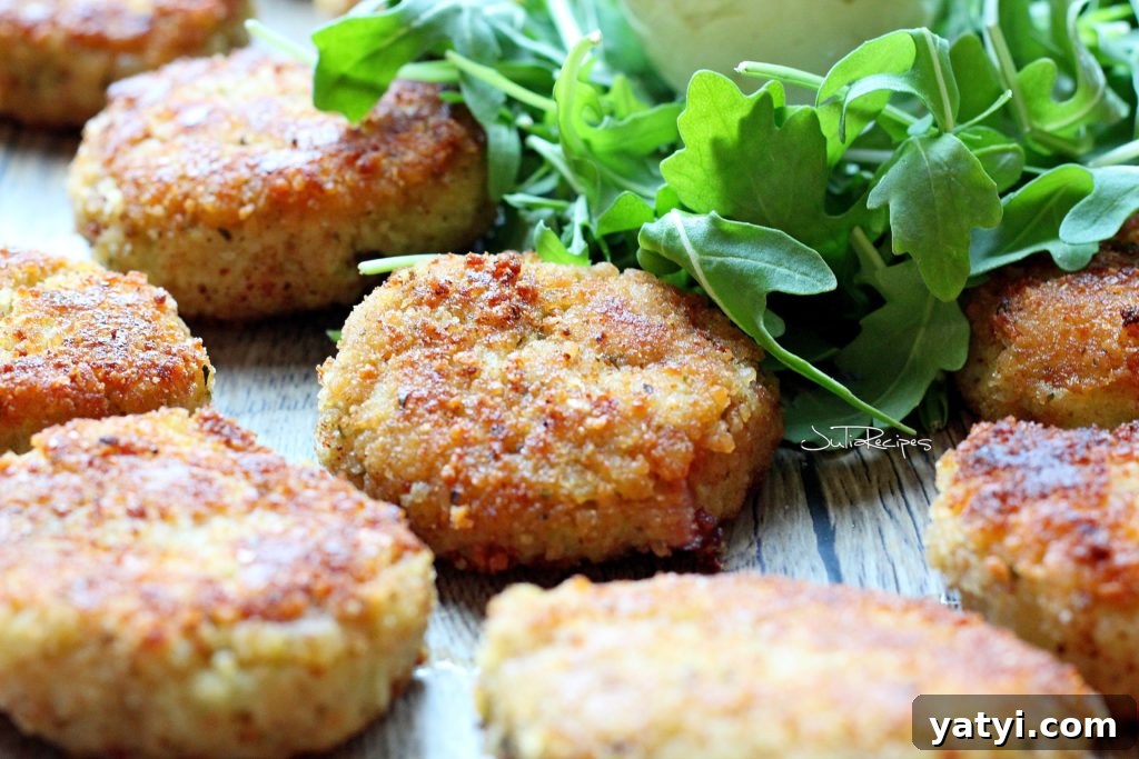 Crispy Cauliflower Fritters with Tangy Curry Dipping Sauce 3 Cauliflower fritters on plate with arugula salad