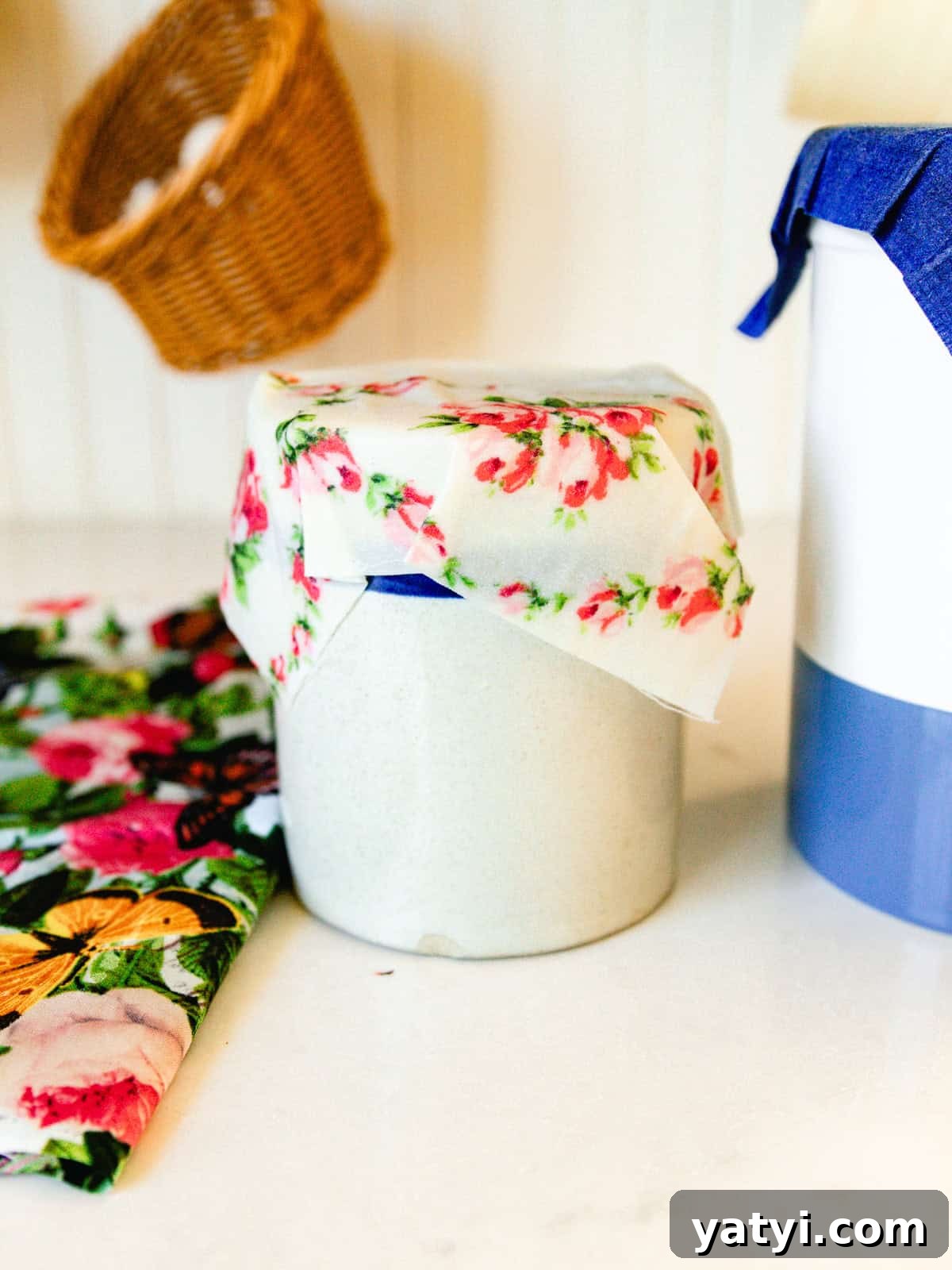 Make Beeswax Food Wraps at Home: Step-by-Step Guide 10 A homemade beeswax wrap covering a crock in a kitchen.