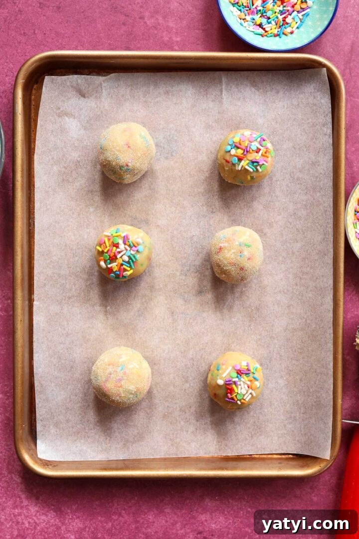 Soft Sprinkle Sugar Cookies Recipe for Perfectly Tender Cookies 7 sprinkle sugar cookie dough balls on baking sheet