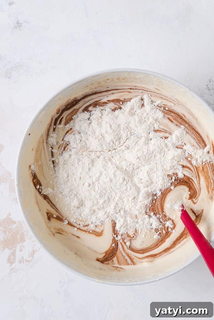 Decadent Chocolate Brownie Pudding Recipe for Chocolate Lovers 10 Adding flour to chocolate pudding mixture.