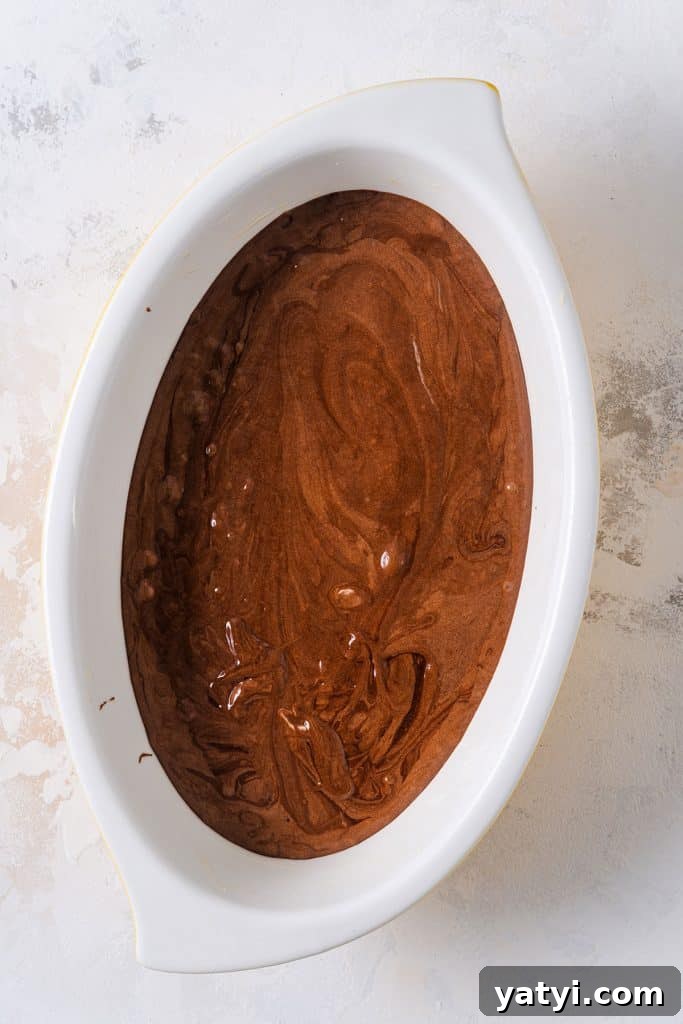 Decadent Chocolate Brownie Pudding Recipe for Chocolate Lovers 12 Chocolate batter in an oval baking dish.