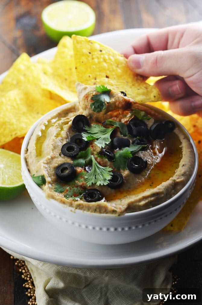 Jalapeño Pinto Bean Dip with Roasted Garlic and Lime 2 Jalapeno Pinto Bean "Hummus". This creamy dip is like a hybrid between spicy refried beans and hummus. Perfect for a party! | hostthetoast.com