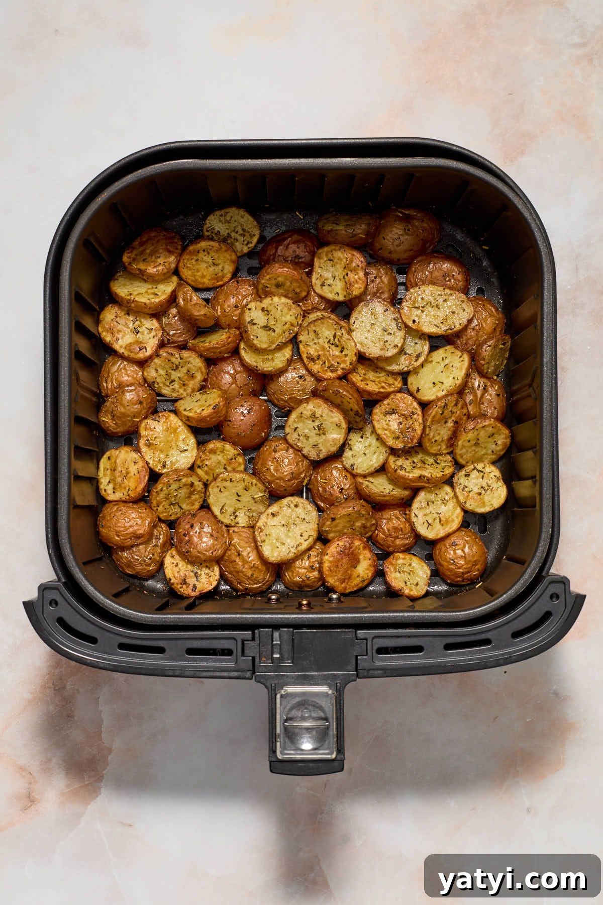 Crispy Air Fryer Baby Potatoes — 4 Ingredients Only 7 Air fried baby potatoes in the air fryer basket.