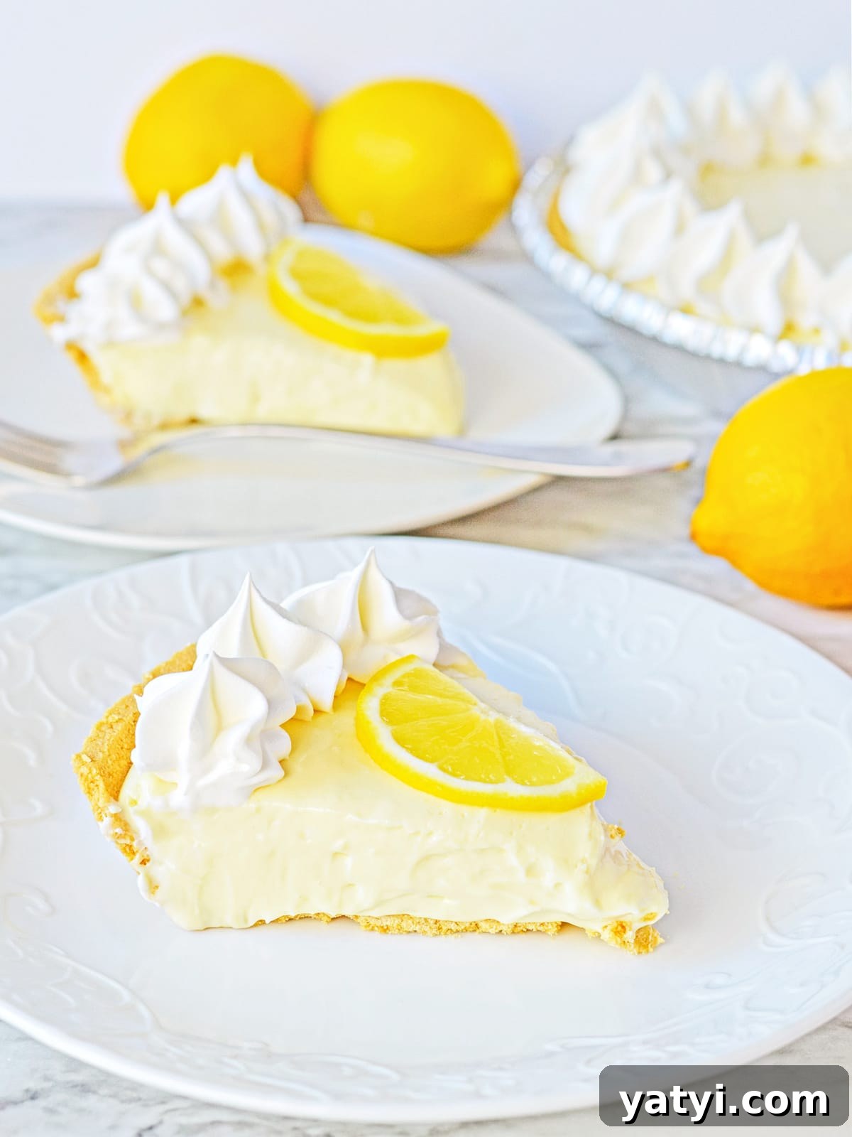 Zesty Lemon Pie with Graham Cracker Crust Recipe 2 no bake lemon cheesecake slices on plates