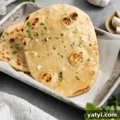 gluten-free naan in a parchment lined baking pan.