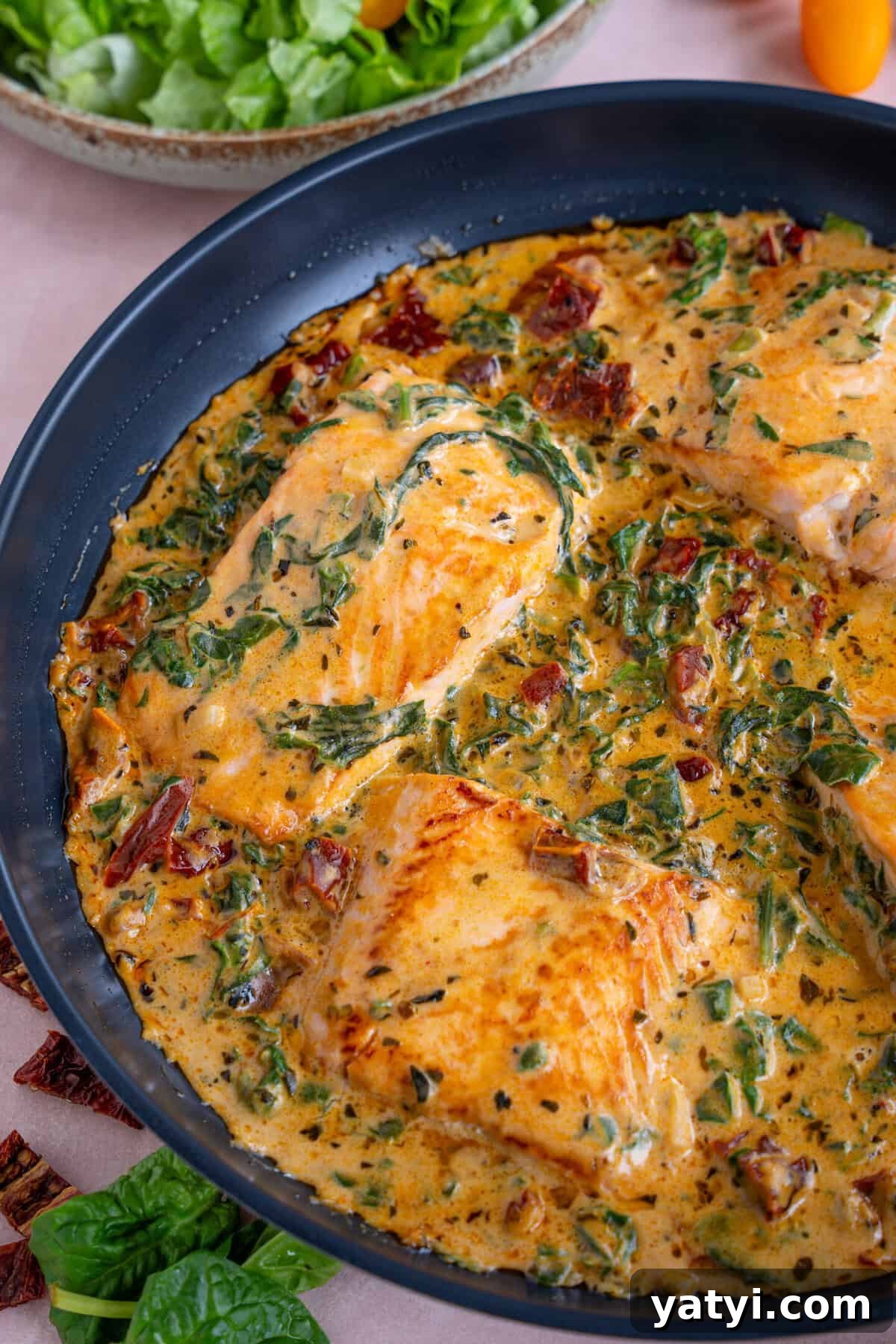 Creamy Tuscan Salmon with Garlic and Sun-Dried Tomatoes 2 A pan of creamy Tuscan salmon.