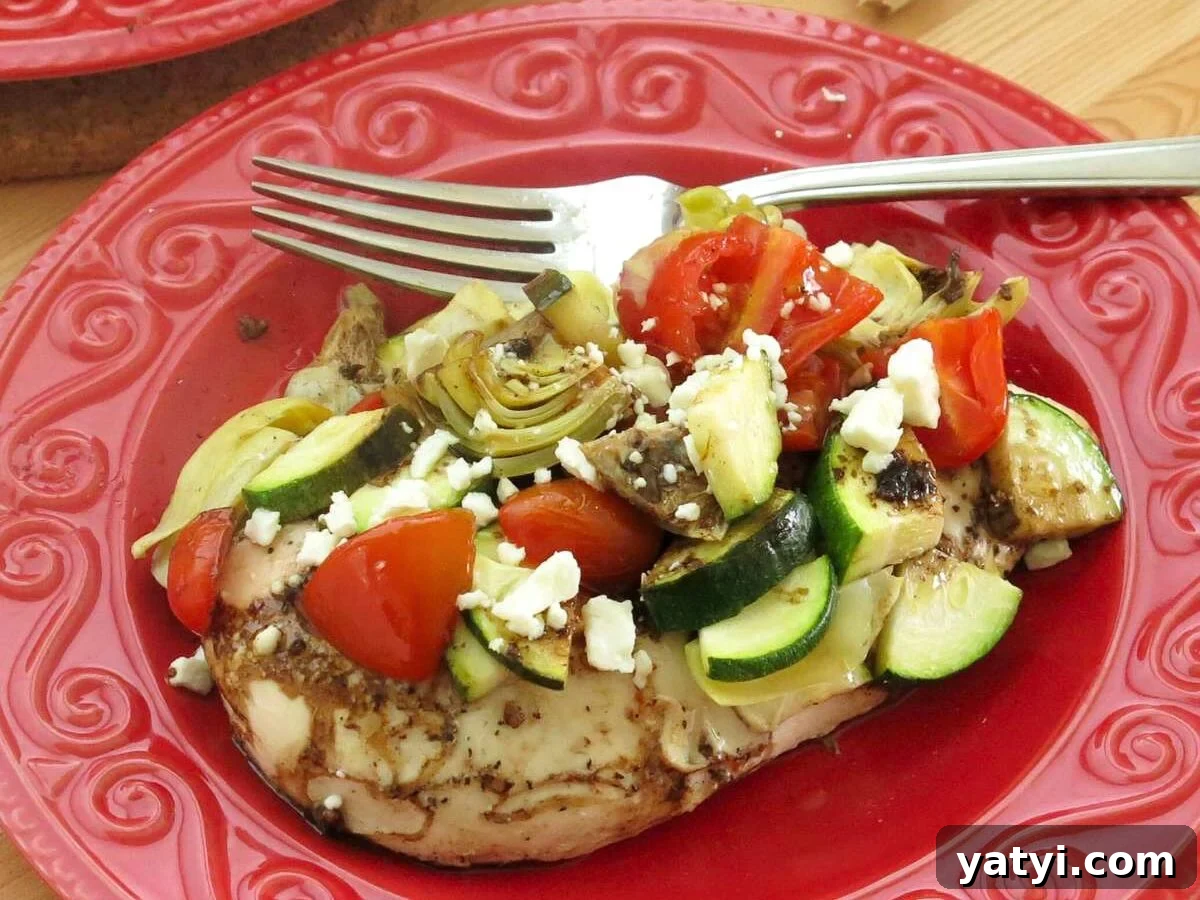 10 Quick Weeknight Dinners to Save Your Evenings 5 Mediterranean baked chicken with zucchini, tomatoes, and feta on a red plate.