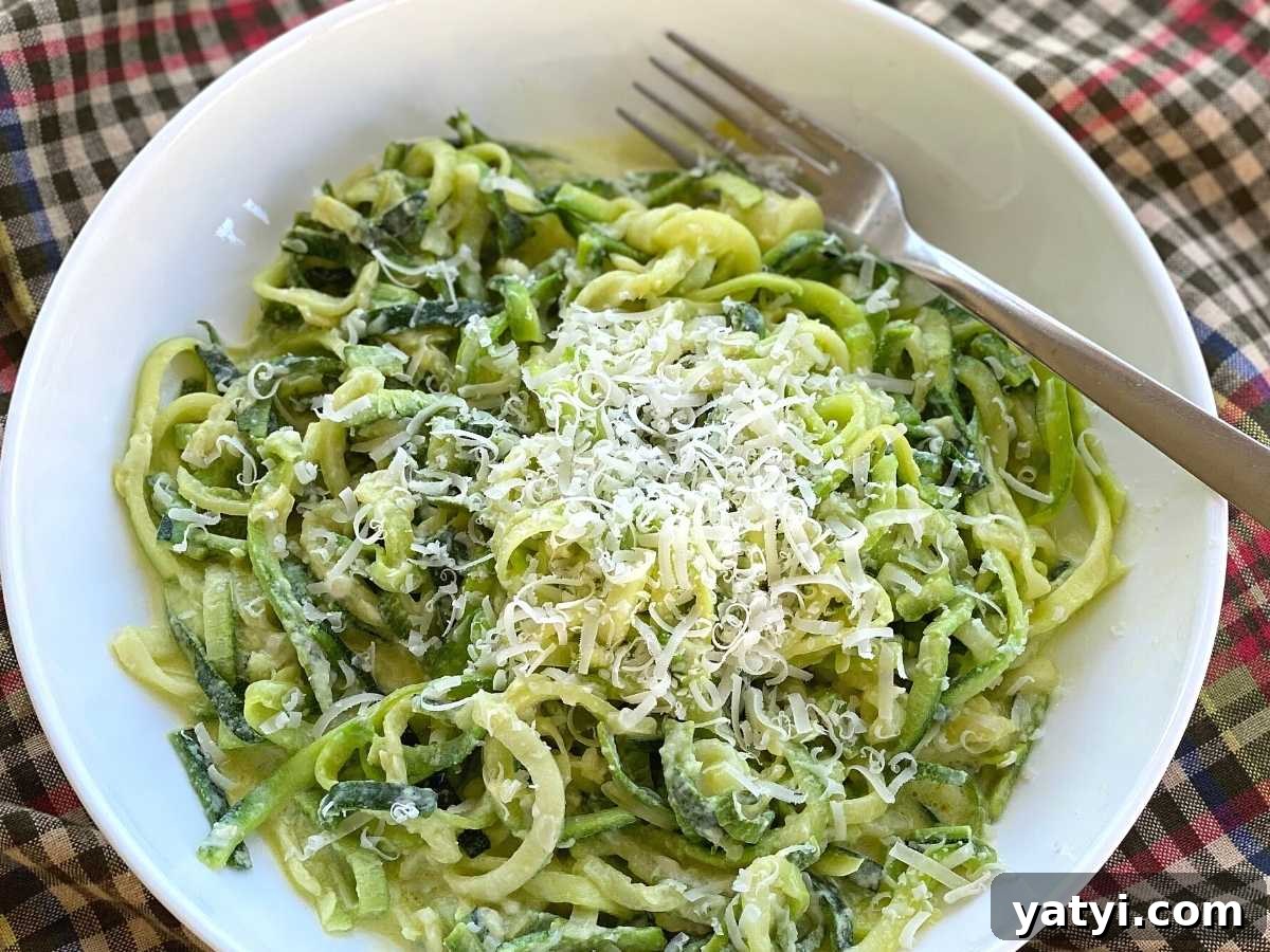 10 Quick Weeknight Dinners to Save Your Evenings 10 Plate of zucchini noodle alfredo in a white bowl with a fork.