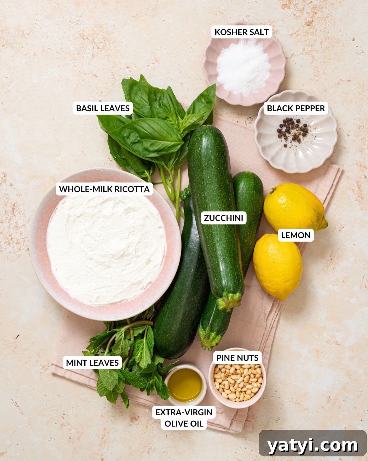 Zucchini Ribbon Salad with Whipped Lemon Ricotta Dressing 6 Ingredients for no-cook zucchini ribbon salad arranged on a light surface.