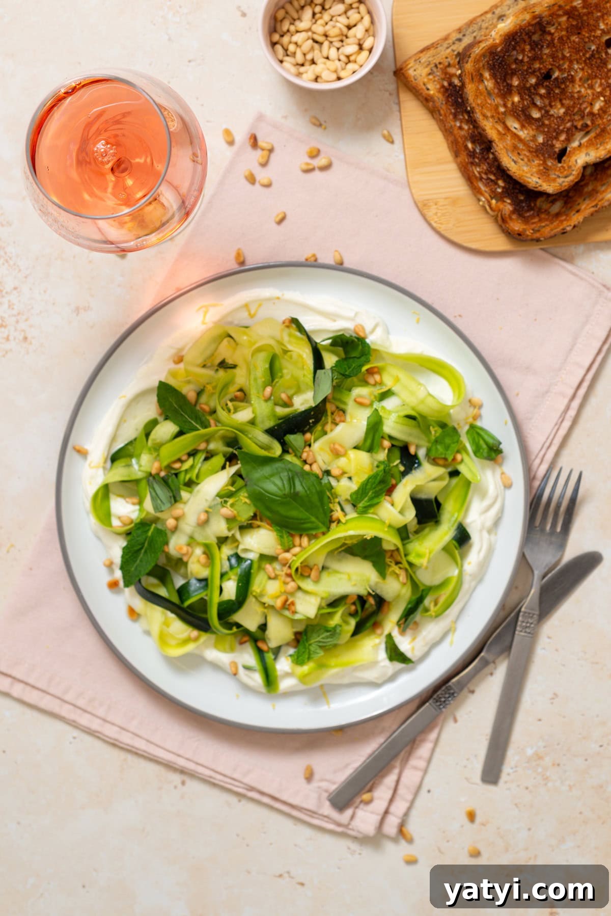 Zucchini Ribbon Salad with Whipped Lemon Ricotta Dressing 10 Finished zucchini ribbon salad with whipped ricotta, herbs, lemon zest, and toasted pine nuts plated for serving.