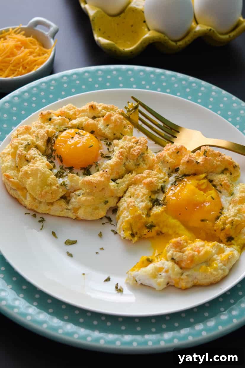 Cheddar Bay Egg Fluffs: Savory Baked Egg Cups with Cheddar Bay Biscuit Flavor 3 Cheddar bay egg fluffs on white plate with gold fork close up