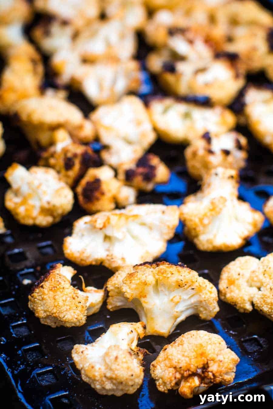 Citrus-Garlic Grilled Cauliflower Steaks with Herb Chimichurri 2 Grilled cauliflower on a black tray