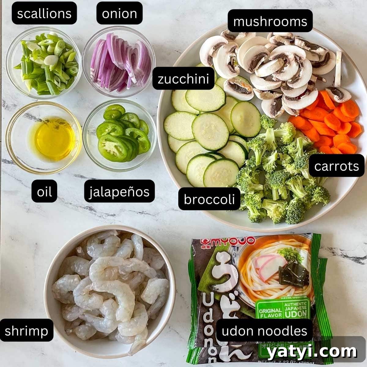 The labeled ingredients for shrimp yaki udon are shown on a white marble counter.