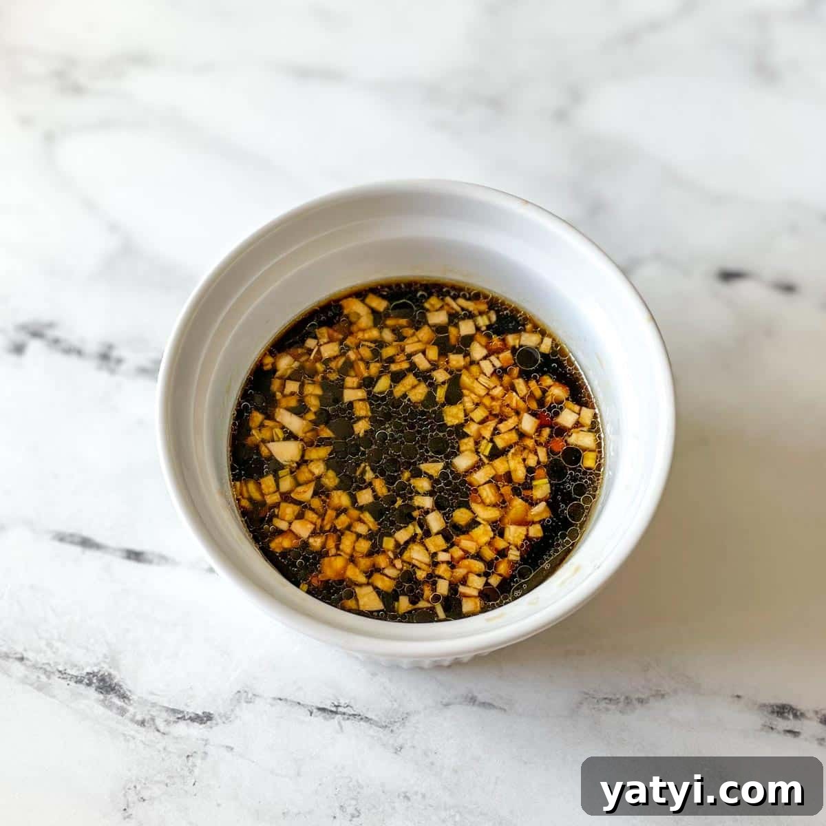 The marinade is shown in a white bowl.