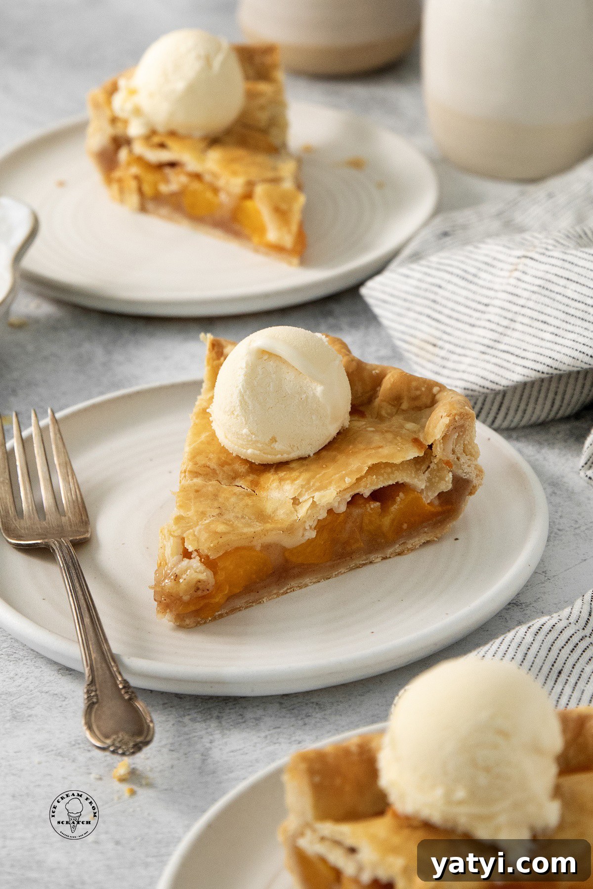 Classic Peach Pie Recipe Using Canned Peaches 2 Slices of canned peach pie topped with vanilla ice cream.