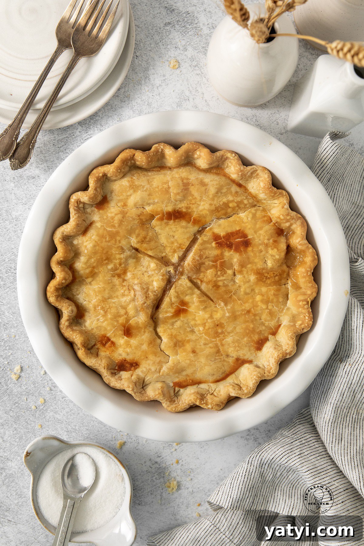 Classic Peach Pie Recipe Using Canned Peaches 4 a baked peach pie in a white ceramic pie dish, viewed from above.