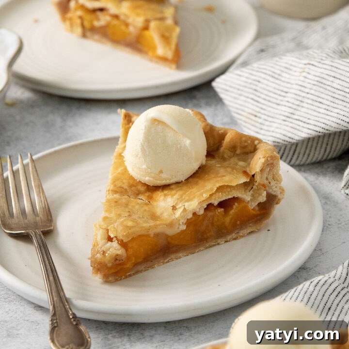 Slices of canned peach pie topped with vanilla ice cream.