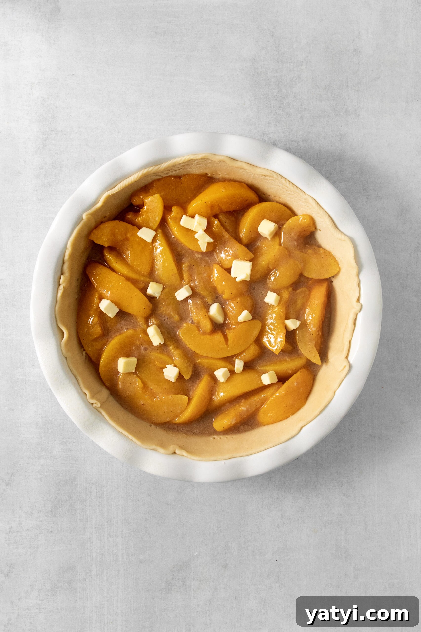 Classic Peach Pie Recipe Using Canned Peaches 9 peach filling in a pie crust topped with butter pieces