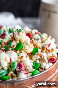Christmas Crunch Close Up Close up of popcorn snack in a copper tin with a dark blue background.