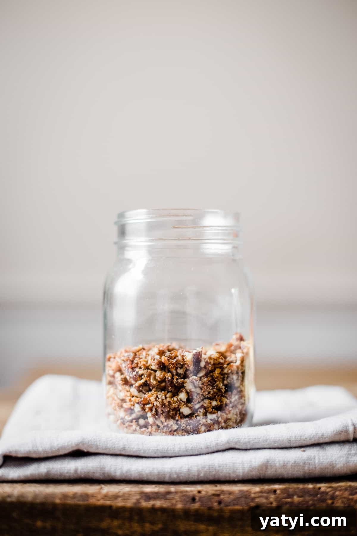 Gluten-Free Golden Beet and Carrot Cake Recipe 5 pecans in a jar on a tea towel