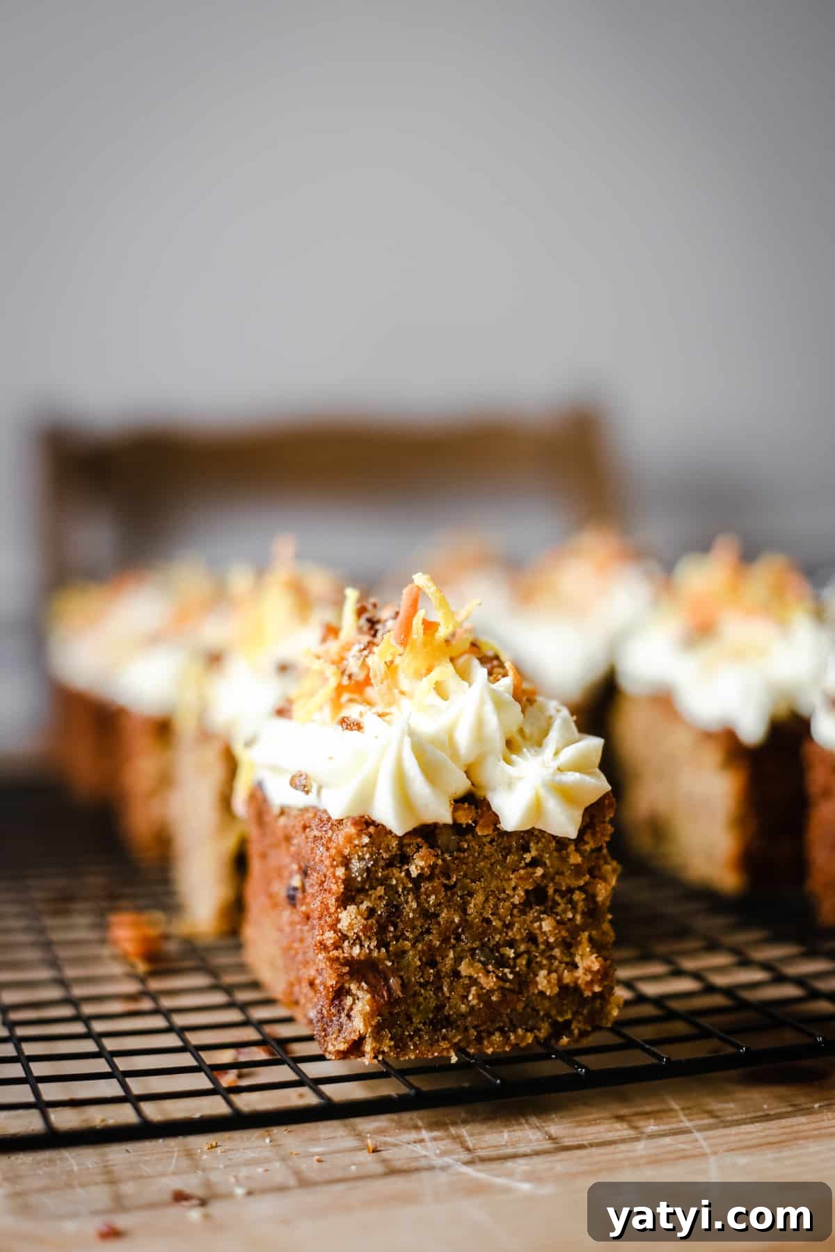 Gluten-Free Golden Beet and Carrot Cake Recipe 7 A close up of a pieces of cake sitting on a wire rack on top of a table