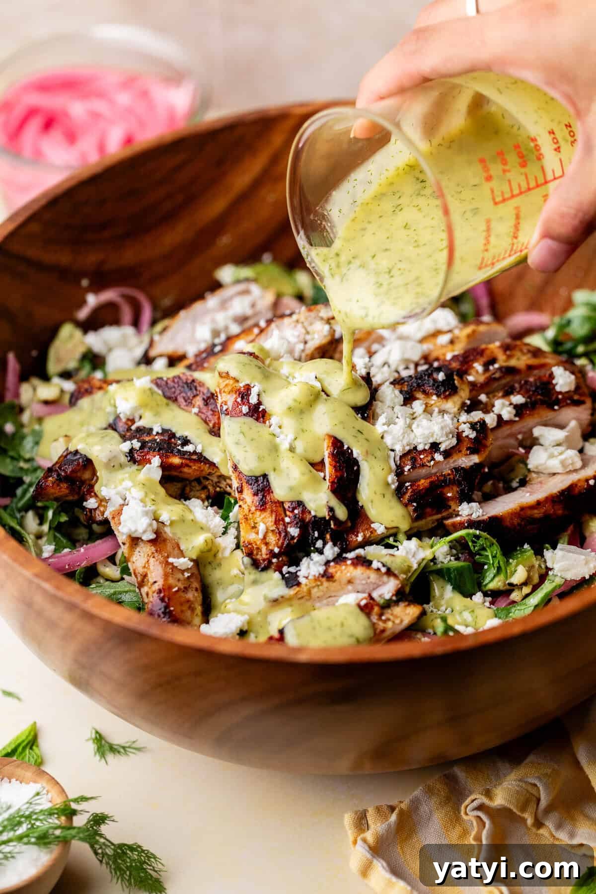 pouring dressing on salad